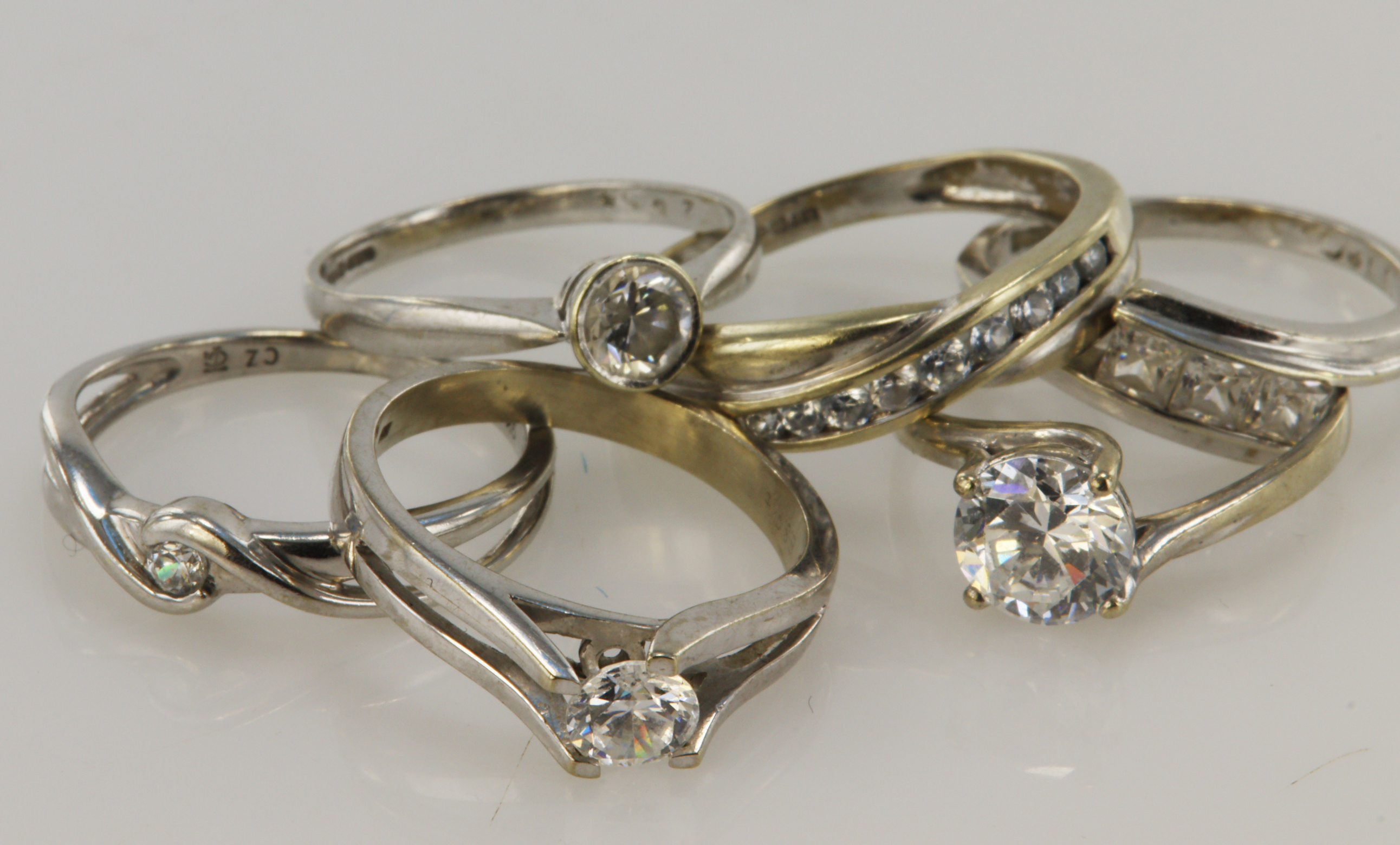 Six 9ct gold/tests 9ct CZ rings, stones include K/L, Lx2, M, N/O, P/Q, total weight 11.9g.