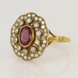 18ct yellow gold diamond and ruby cluster ring, one oval ruby measuring approx. 7 x 5mm,