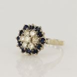 White gold (tests 18ct) diamond and sapphire cluster ring, seven round brilliant cut diamonds TDW