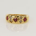 18ct yellow gold Edwardian diamond and ruby gypsy ring, set with three round rubies, principle