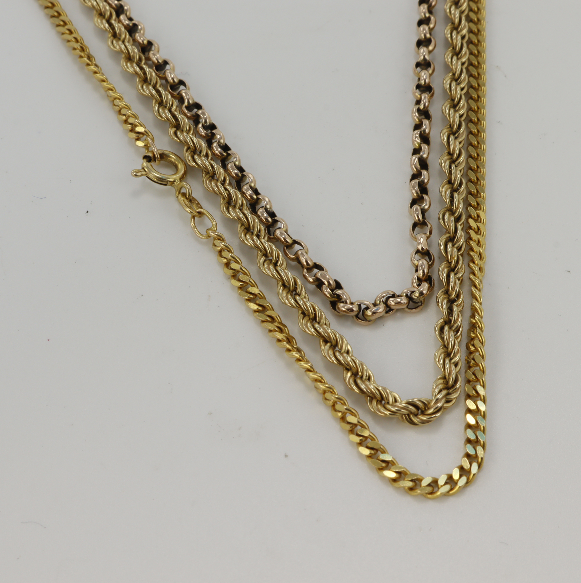 Three 9ct gold/tests 9ct chains, lengths 17", 18"x2, total weight 19g.