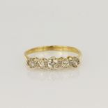 Tested as 18ct yellow gold five stone graduated half eternity ring consisting of a central diamond