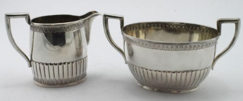 Danish three piece .826 grade silver comprising a long spouted teapot, sugar basin and cream jug