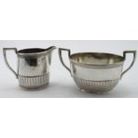 Danish three piece .826 grade silver comprising a long spouted teapot, sugar basin and cream jug