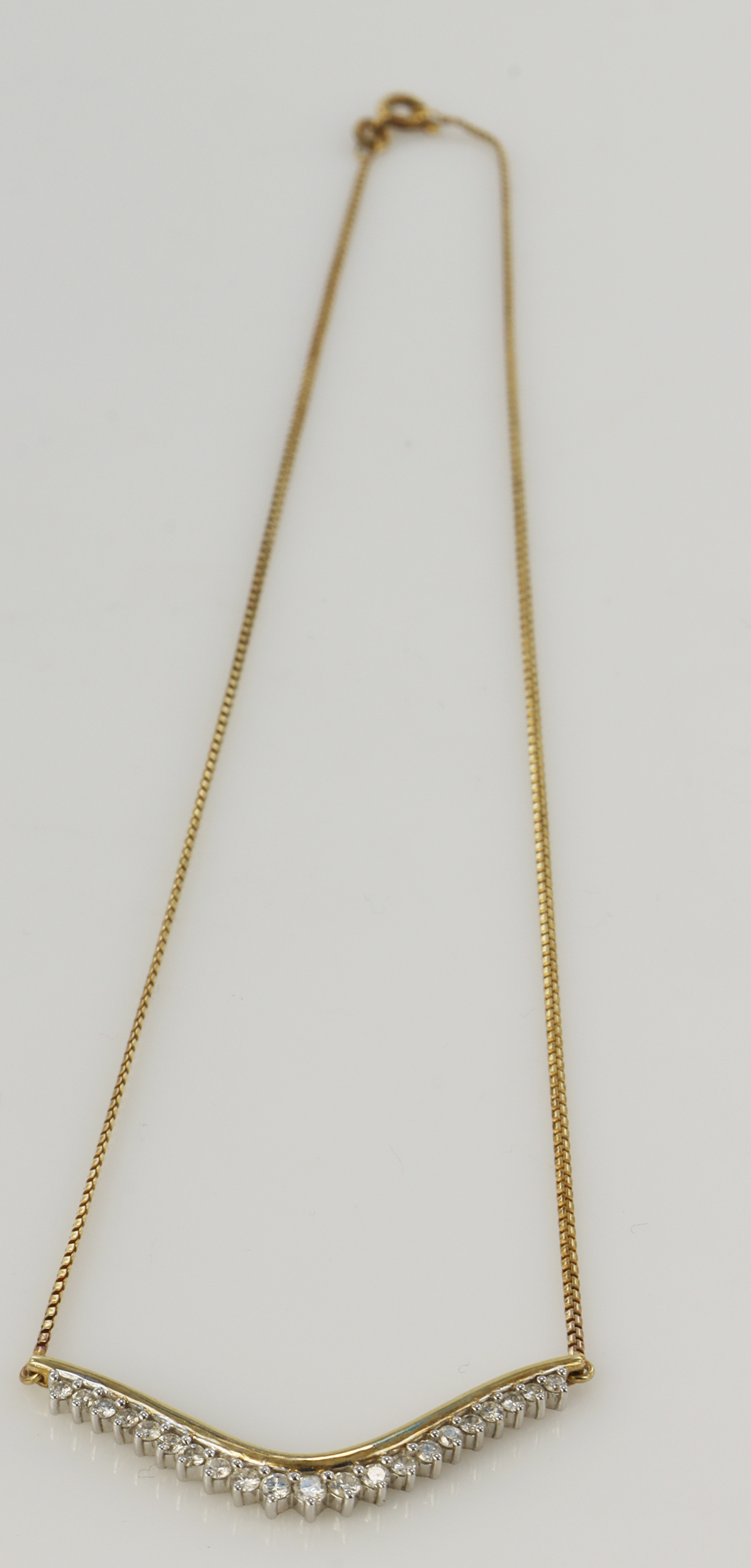 Yellow gold (tests 9ct) diamond wishbone necklace, graduated round brilliants TDW approx. 0.52ct,