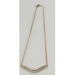 Yellow gold (tests 9ct) diamond wishbone necklace, graduated round brilliants TDW approx. 0.52ct,