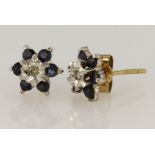 9ct yellow gold cluster earrings set with a central diamond in illusion setting, surrounded by six