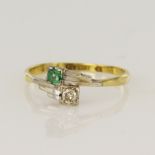 Yellow gold (tests 18ct) vintage diamond and emerald Toi Et Moi ring, one old European cut approx.