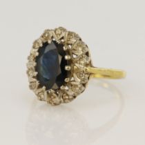 18ct yellow gold diamond and sapphire cluster ring, oval sapphire measures 10 x 7mm, surrounded with