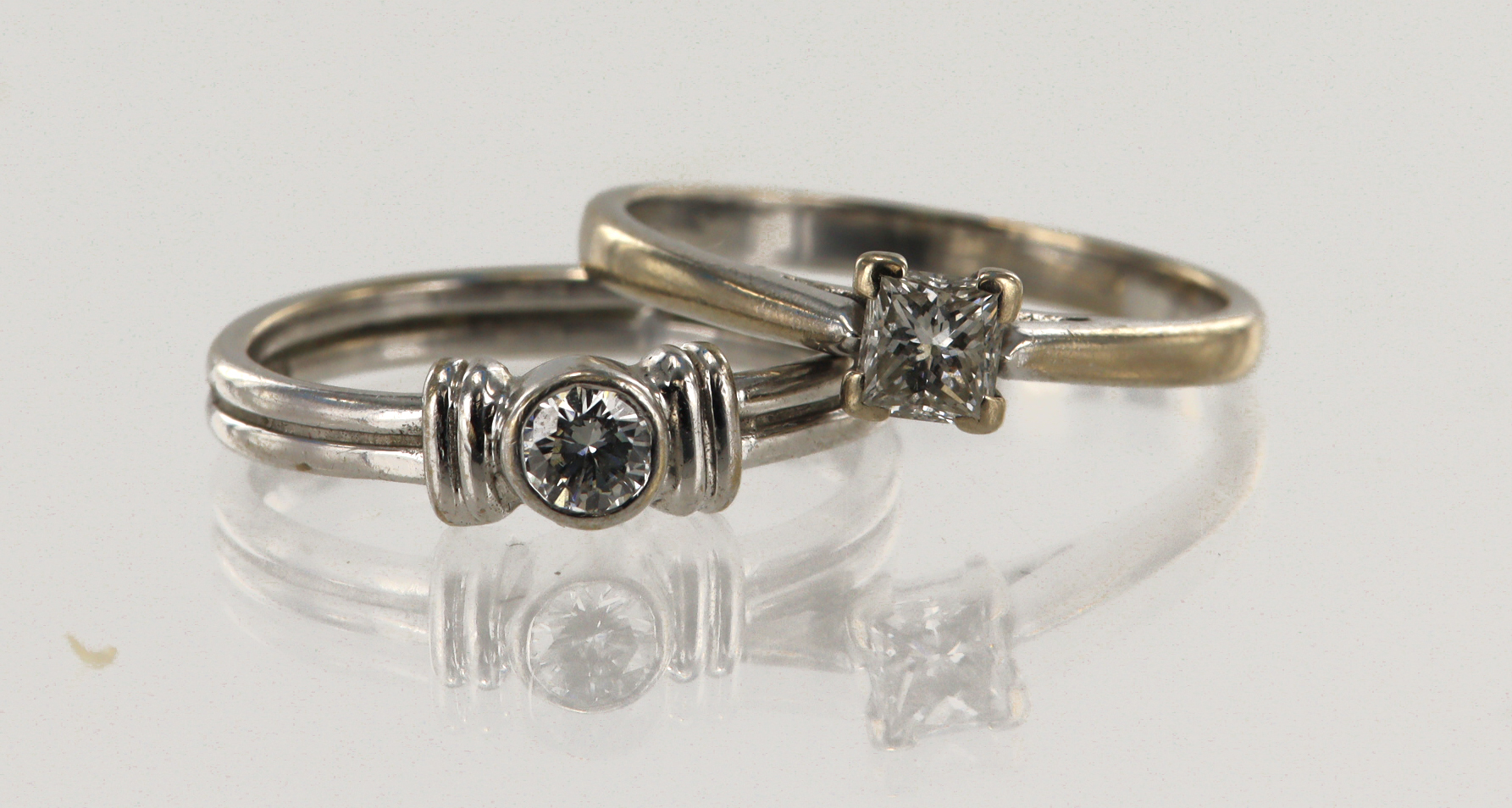 Two 18ct white gold solitaire rings, one princess cut approx. 0.35ct, finger size N. Round brilliant