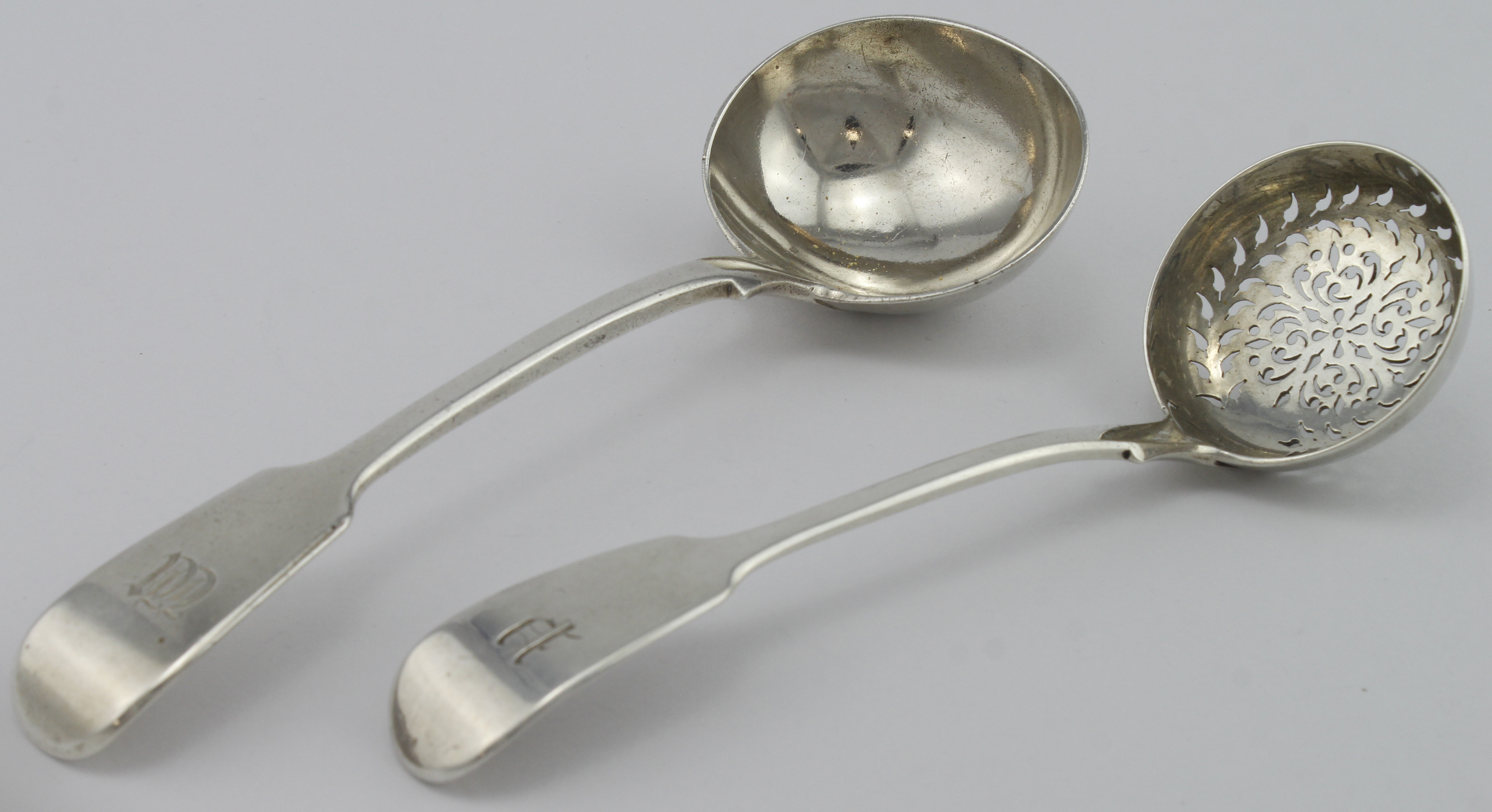 Two Victorian silver fiddle pattern ladles, one is a sugar sifter ladle and one is a sauce ladle,