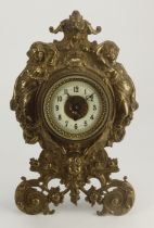 Gilt metal ornately decorated mantel clock, with easel back, enamel chapter ring, movement stamped