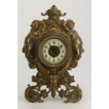 Gilt metal ornately decorated mantel clock, with easel back, enamel chapter ring, movement stamped