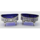 Pair of George III silver open salts with blue glass liners, one of the salts is dented,