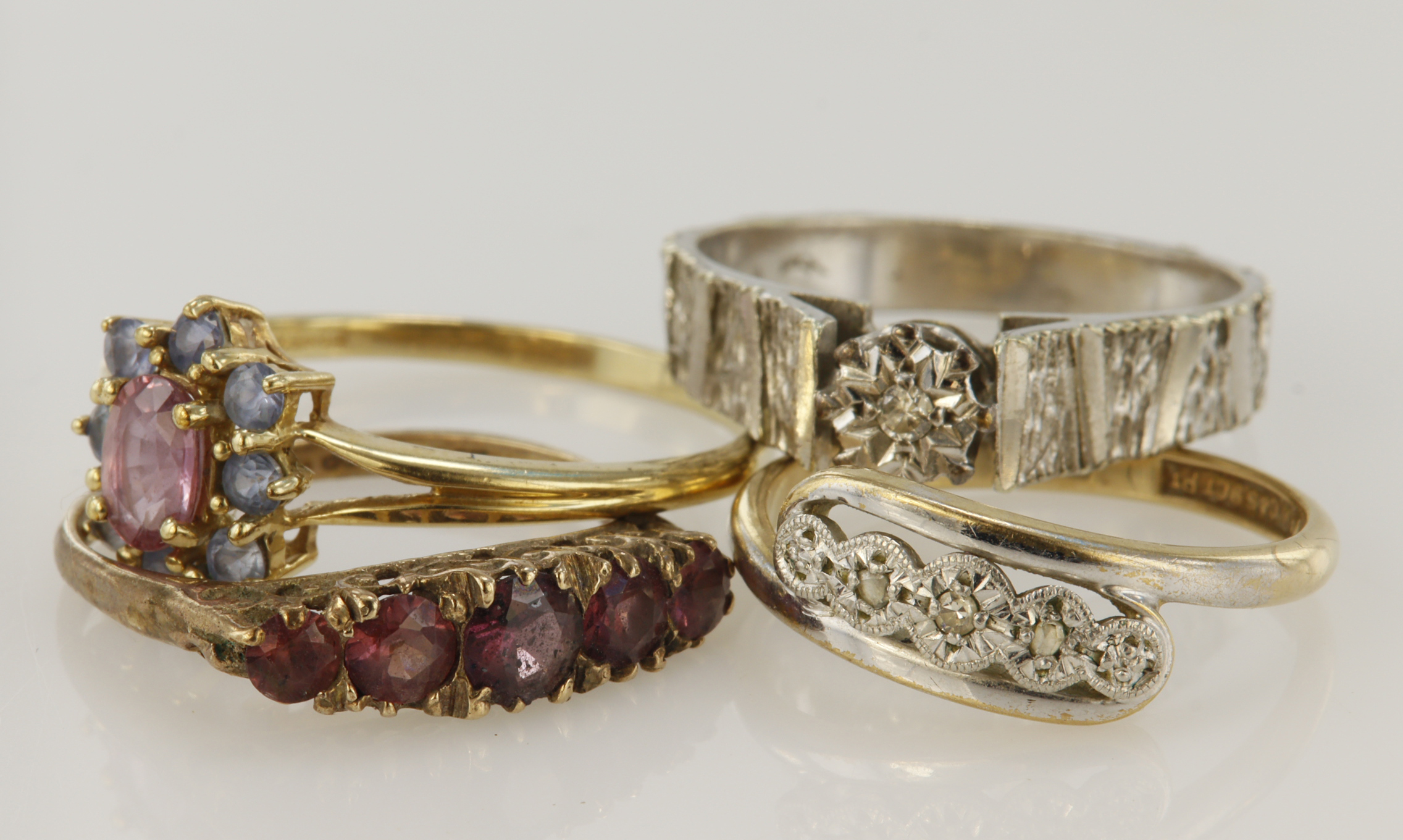 Four 9ct gold/tests 9ct dress rings, stones include diamond, ruby, sapphire, garnet, finger sizes M,