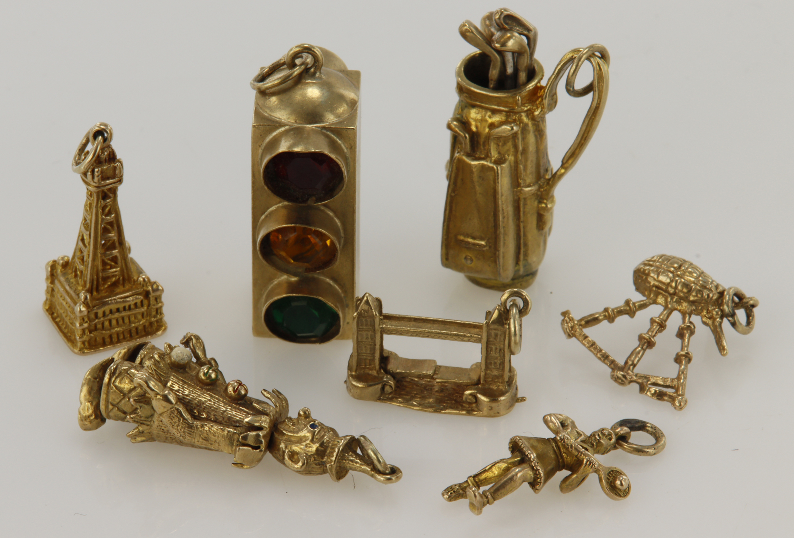 Assortment 9ct gold/tests gold charms, total weight 24.5g.