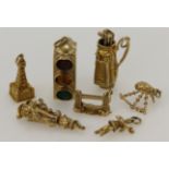 Assortment 9ct gold/tests gold charms, total weight 24.5g.