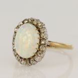 Yellow gold (tests 18ct) vintage diamond and opal cluster ring, one opal cabochon measures 11 x 8mm,