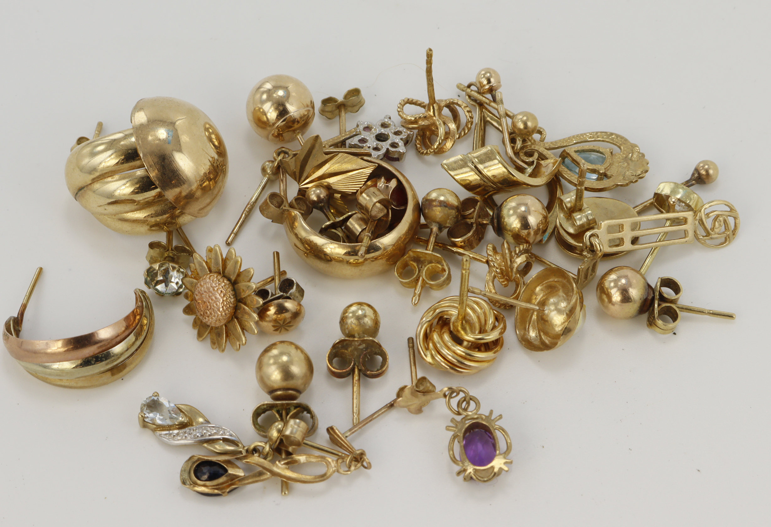 Assortment of yellow gold (tests 9ct) odd earrings, stones include diamond, ruby, sapphire,