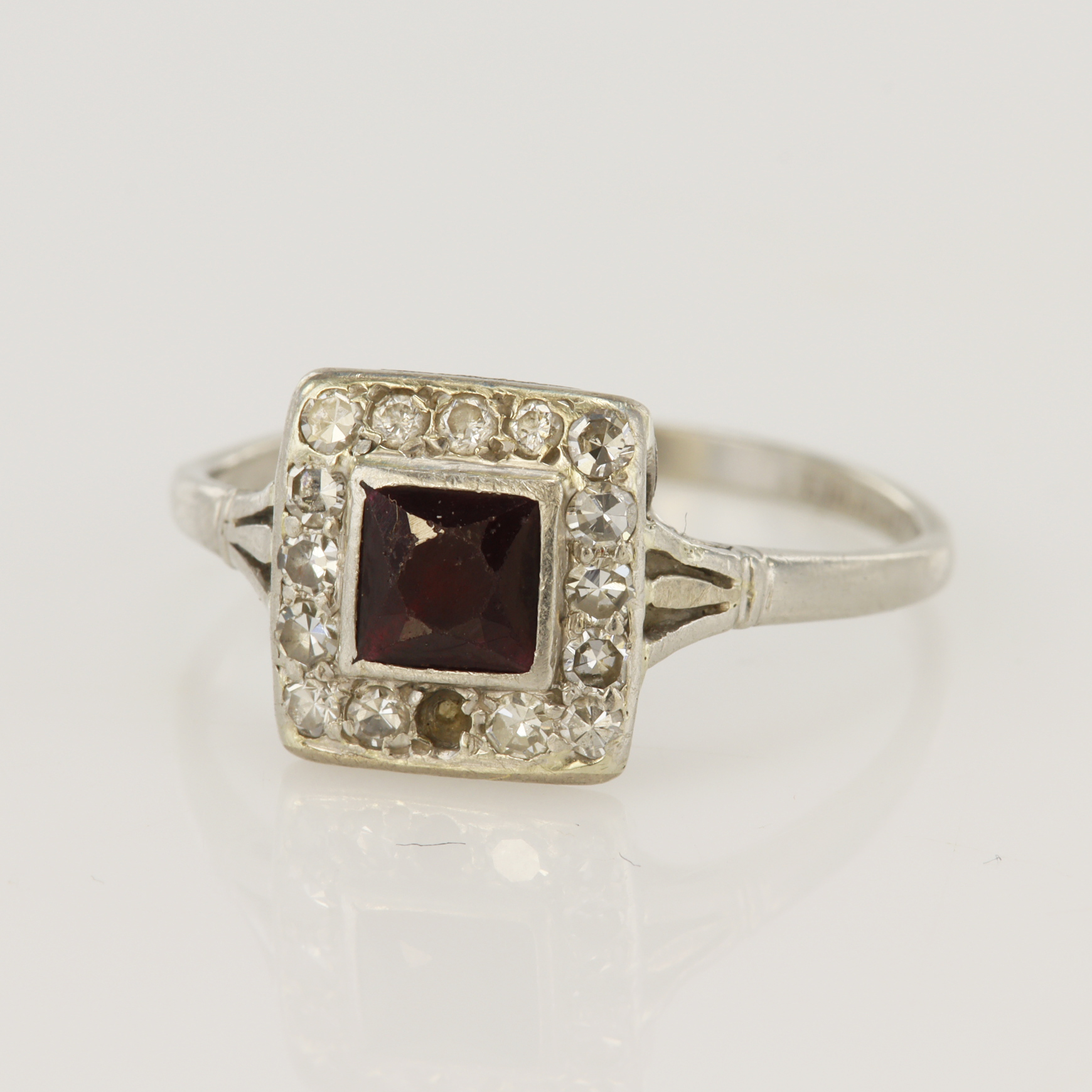 Platinum (tests 980 standard) vintage diamond and ruby cluster ring, French cut ruby measures 4.5mm,