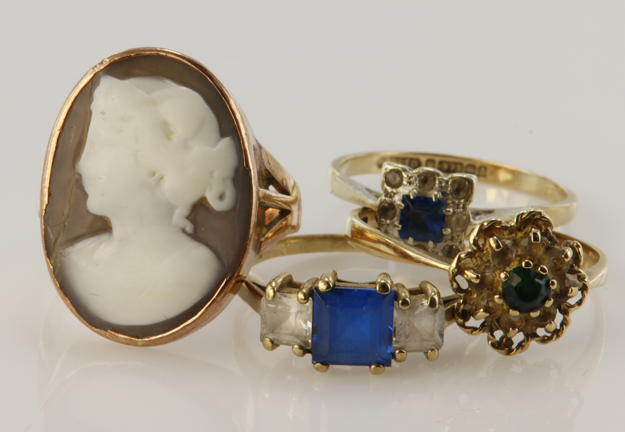 Four 9ct gold/tests 9ct rings, stones include carved shell, paste, finger sizes O/P, Rx3, all with