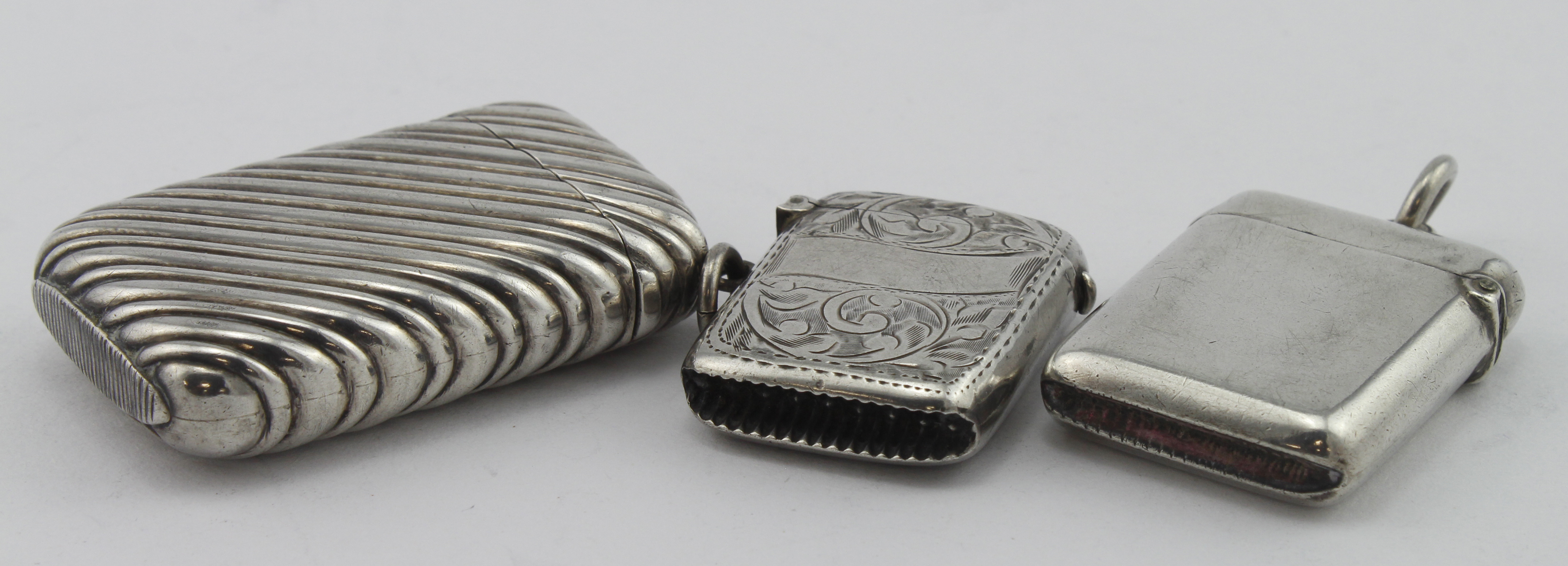 Three silver vesta cases, all three hallmarked, respectively for Birm. 1888, 1895 & 1909, weight