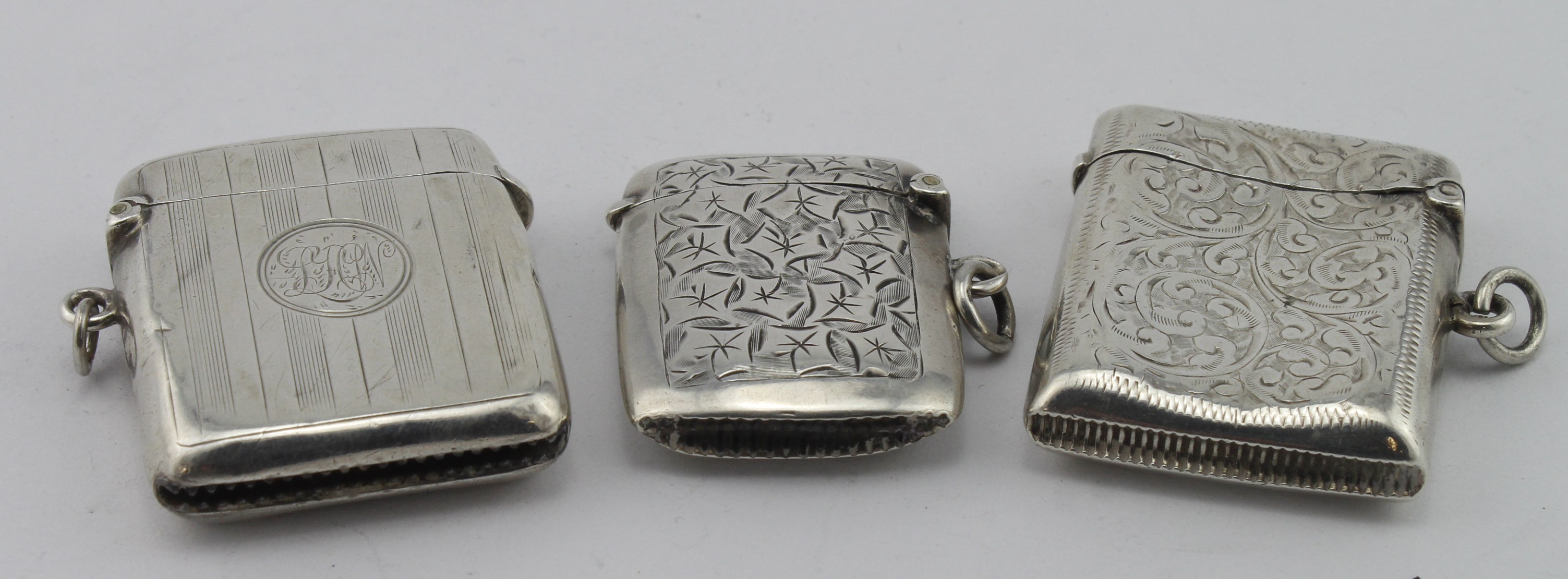 Three silver vesta cases hallmarked Birm. 1900, 1910 & 1915, two are floriate engraved, weight of