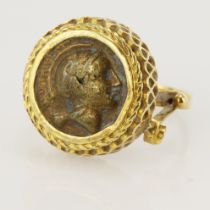 Yellow gold (tests 18ct) mounted ring, with ancient coin styled center, head diameter 19mm, finger