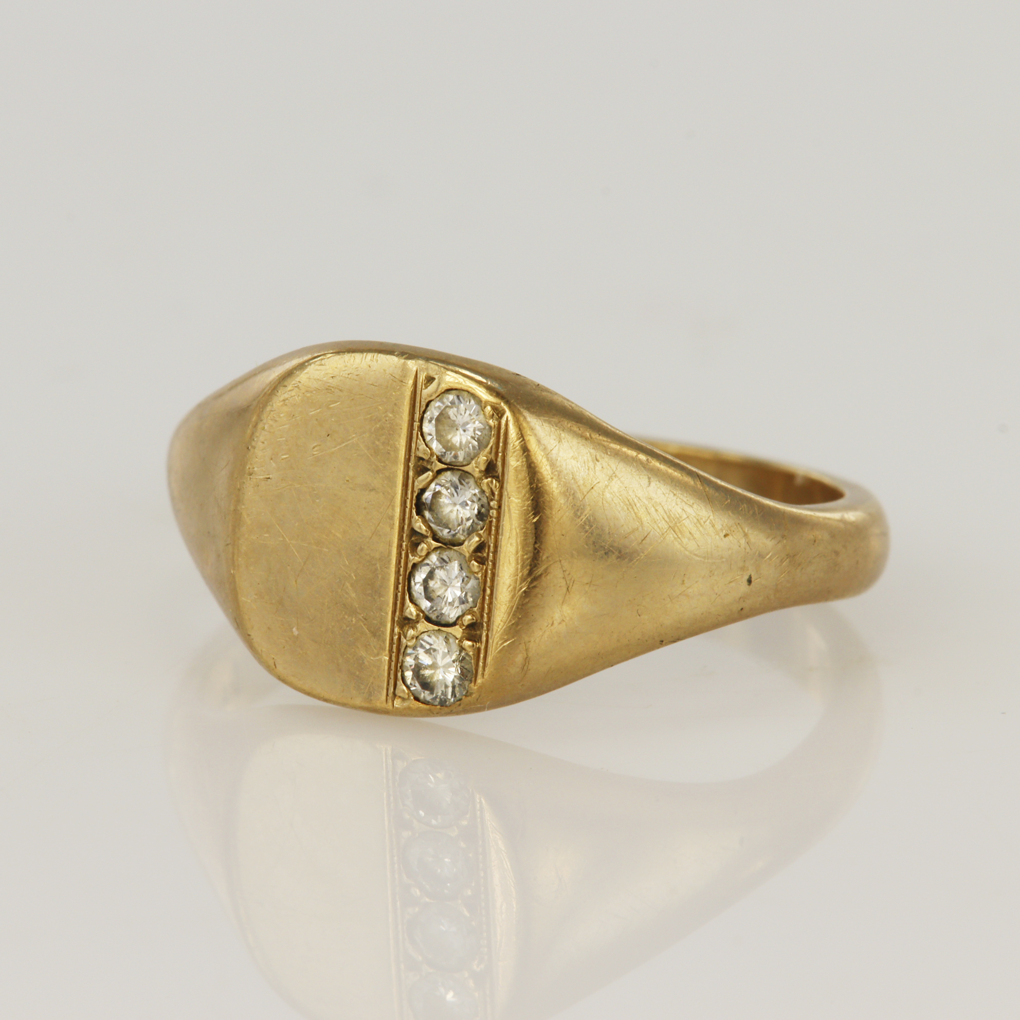 9ct yellow gold diamond signet ring, cushion table set with four round brilliants, TDW approx. 0.
