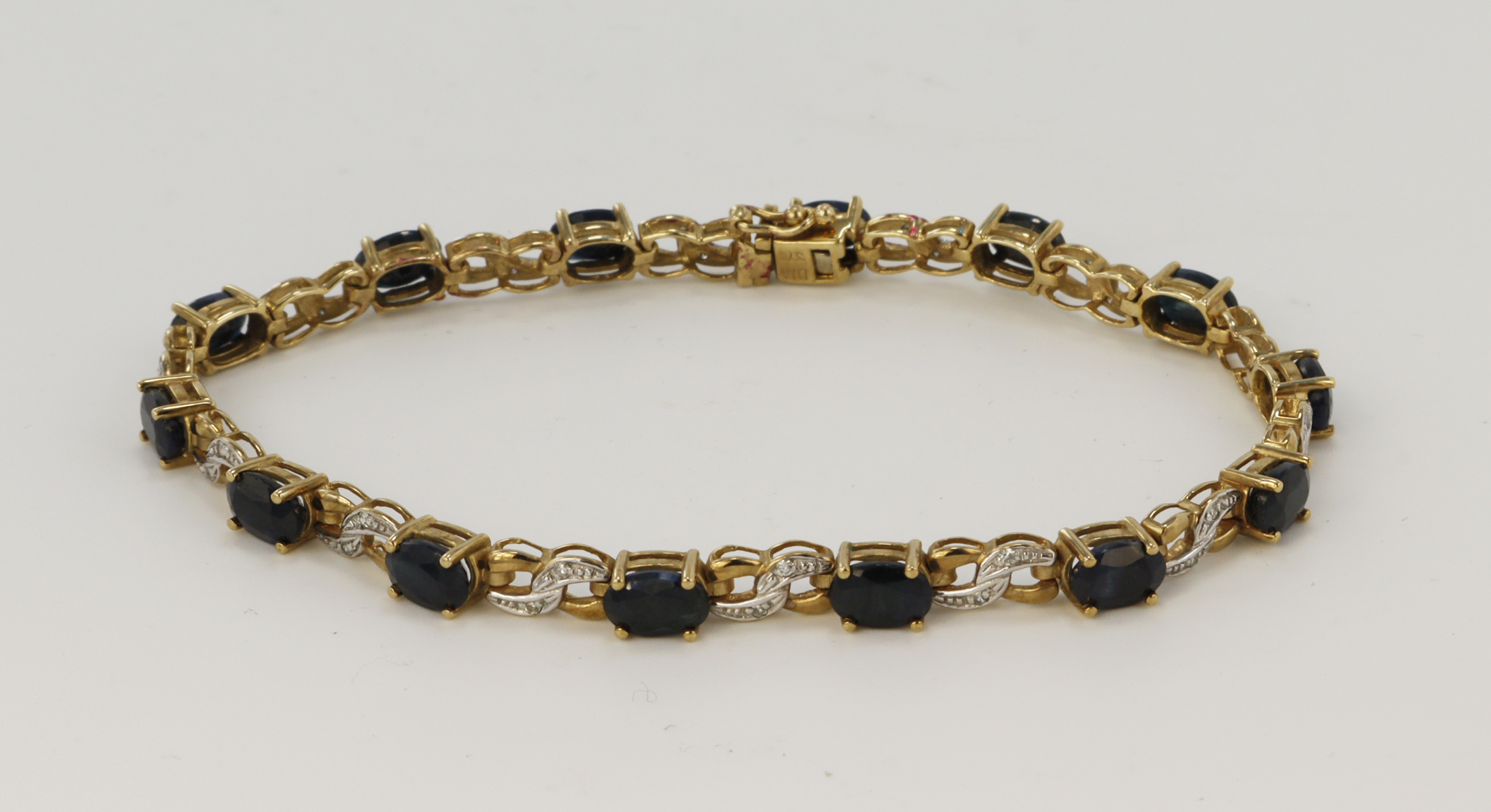 9ct yellow gold diamond and sapphire bracelet, fourteen oval sapphires measuring approx. 6 x 4mm,