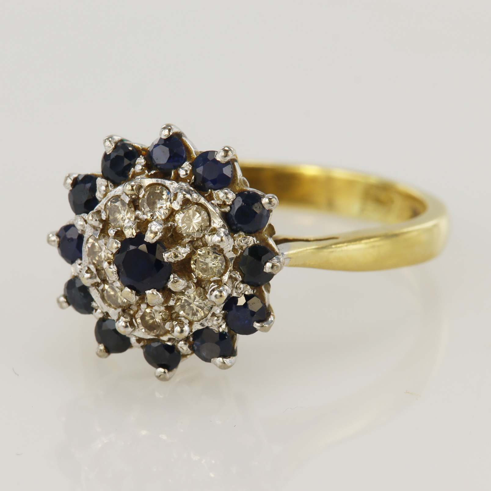 18ct yellow gold diamond and sapphire cluster ring, principle sapphire measures 3mm, eight round