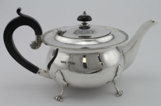 Silver three piece teaset comprising teapot (with wooden handle) cream jug & sugar bowl, all