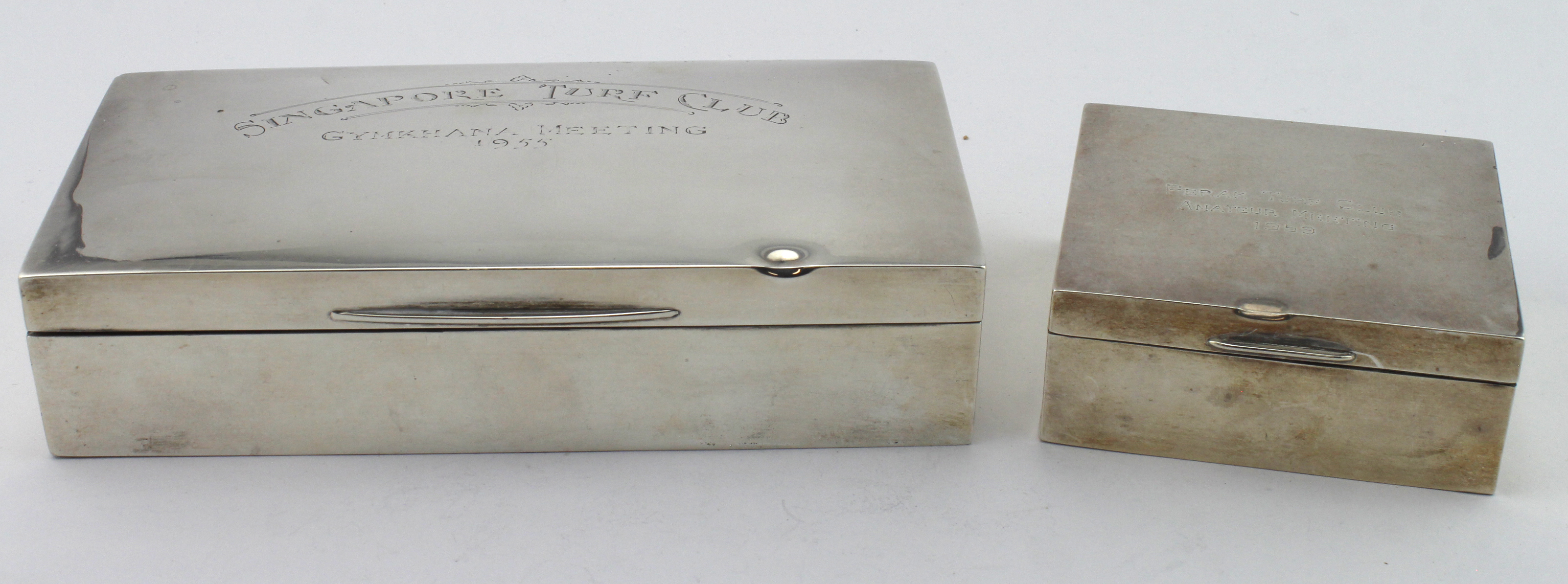 Two silver cigarette boxes, both have wooden interiors, hallmarked Birm. 1930 (worn marks) & Birm.