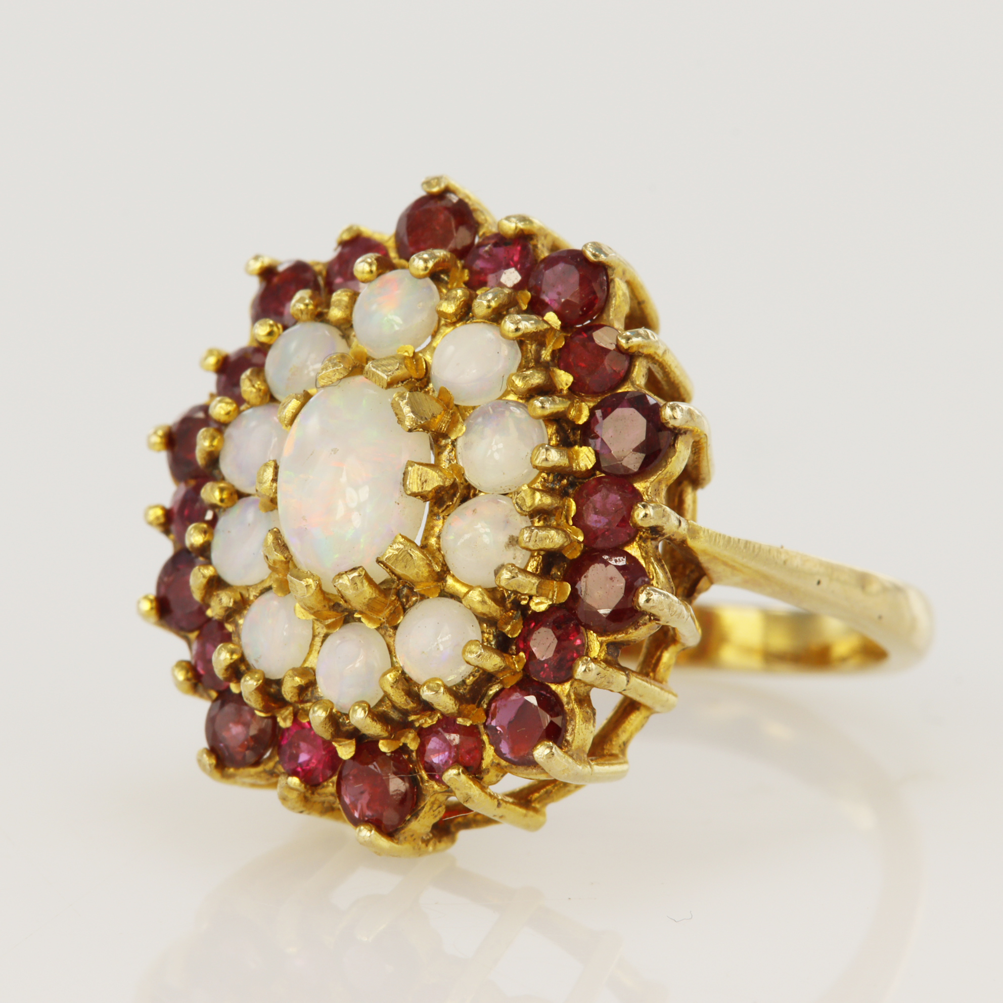 9ct yellow gold ruby and opal cluster dress ring, principle oval opal measures 7 x 5mm, surrounded