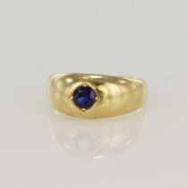 14ct yellow gold flared band ring set with a single round 4mm diameter sapphire in a Gypsy style