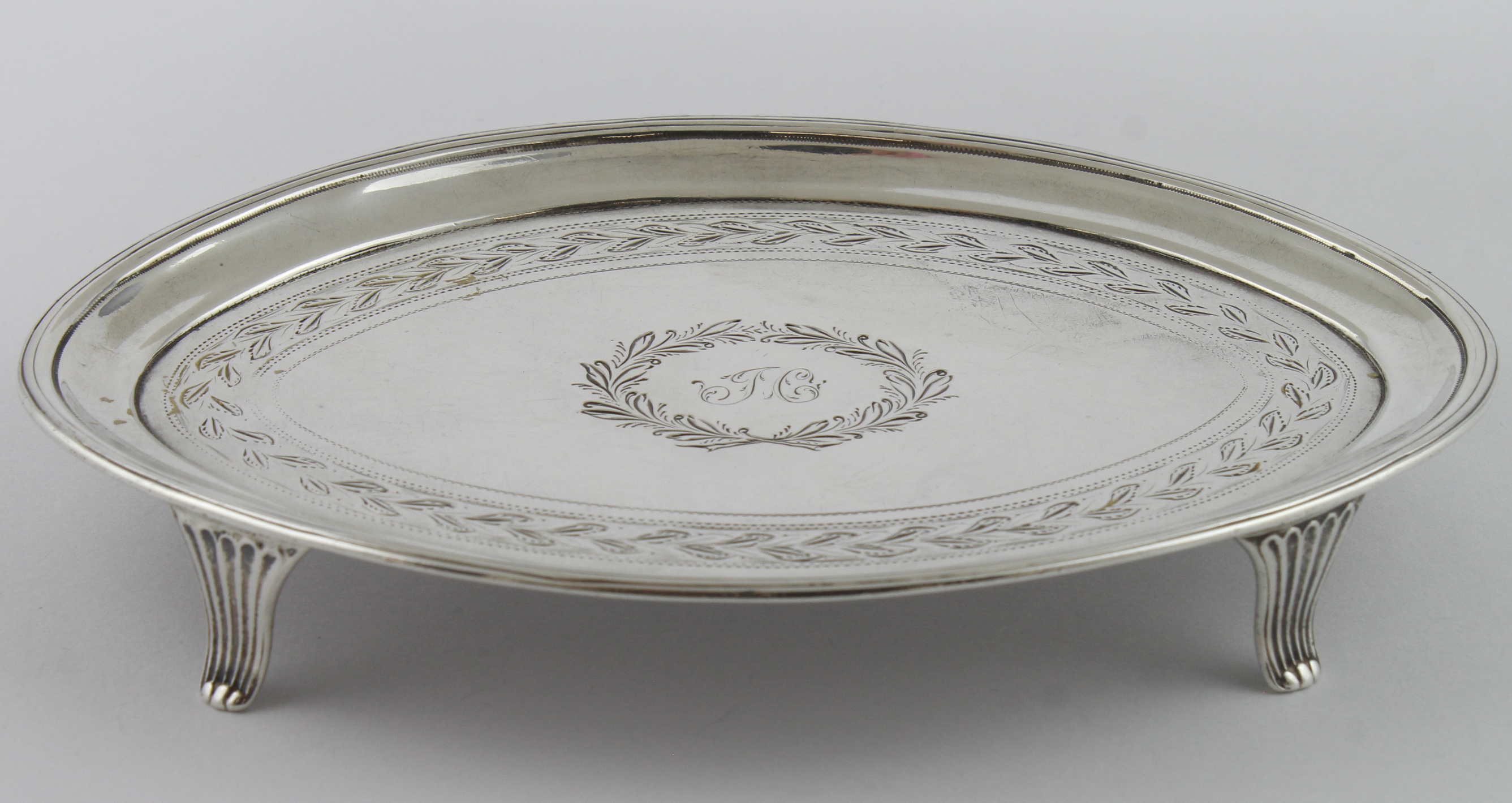 George III silver bright-cut teapot stand on four feet, initials to the centre of the top,