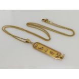 Yellow gold (tests 14ct) Egyptian cartouche pendant, length 50mm, weight 3. Suspended from a