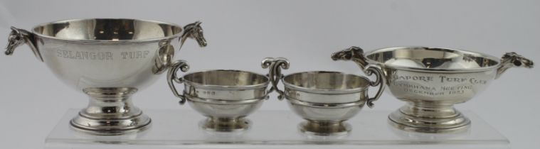 Two small silver horse related trophy cups both have two horses heads as handles, one is for the