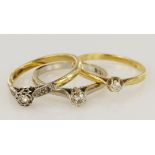 Three gold (test 18ct) diamond solitaire rings, diamond weights approx. 0.06ct, 0.13ct, 0.15ct,