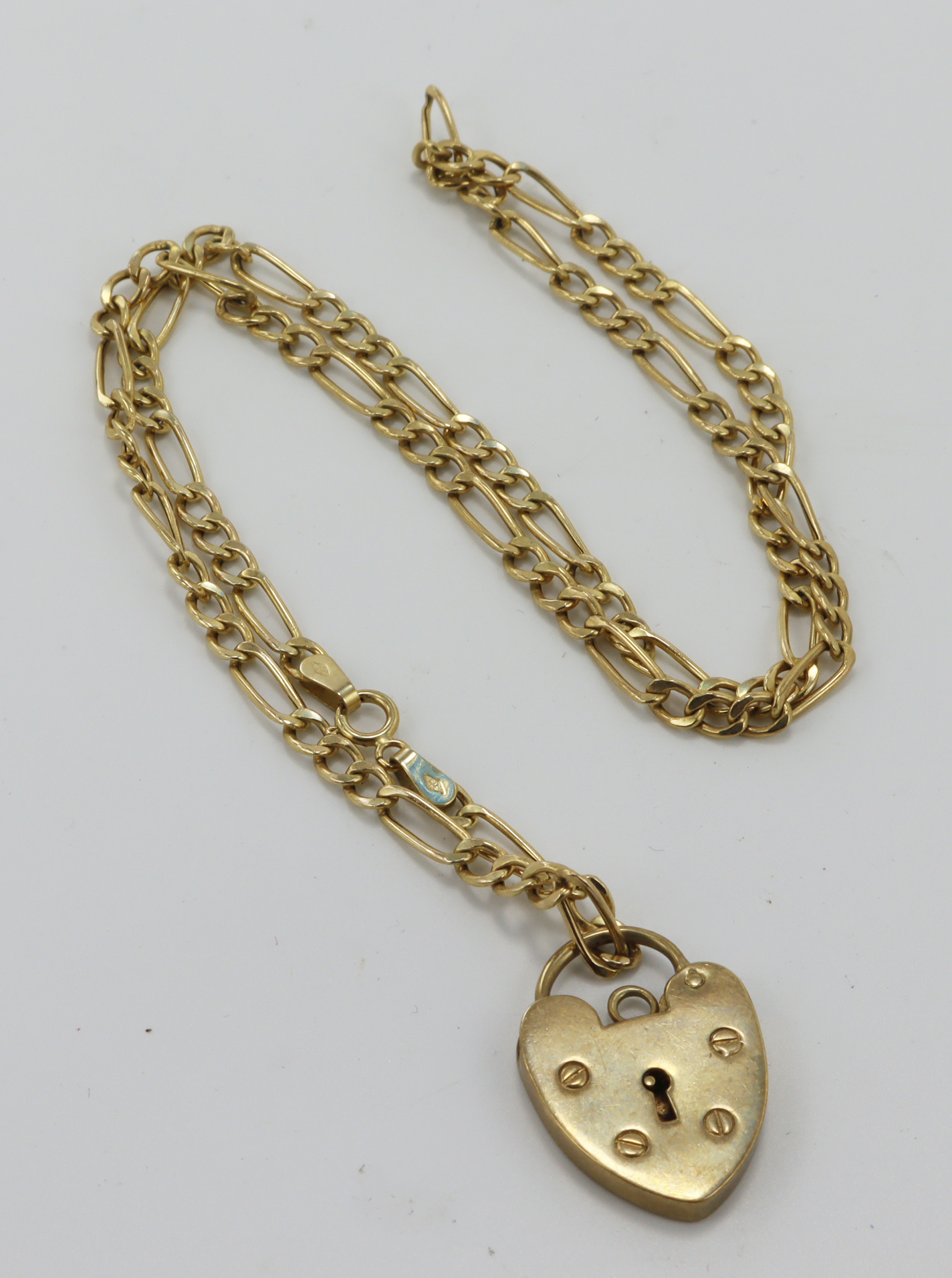 9ct yellow gold heart padlock and figaro chain, heart padlock length 23mm, suspended from an 18"