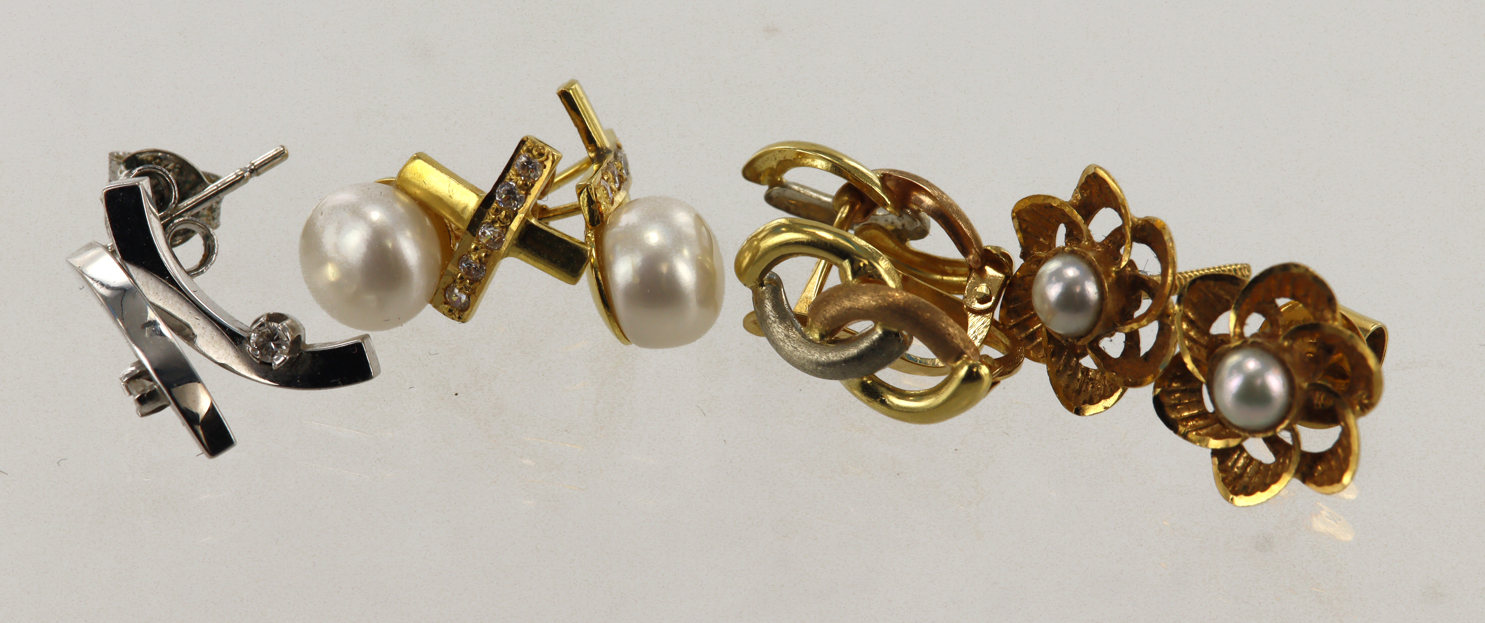 Four pairs of 18ct gold/tests 18ct earrings, stones include diamond, cultured pearl, fresh water