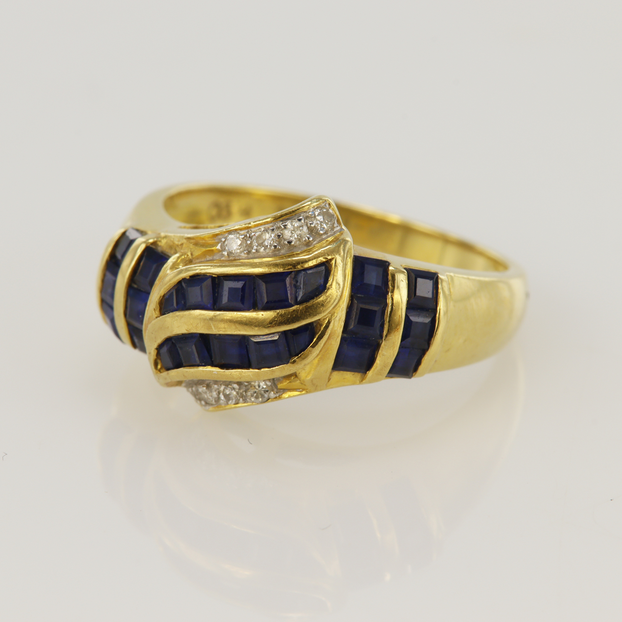 Yellow gold (tests 18ct) diamond and sapphire dress ring, twenty-two calibre cut sapphires, eight