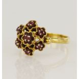 Yellow gold (tests 18ct) ruby floral cluster ring, seven rubies surrounded with red enamel,