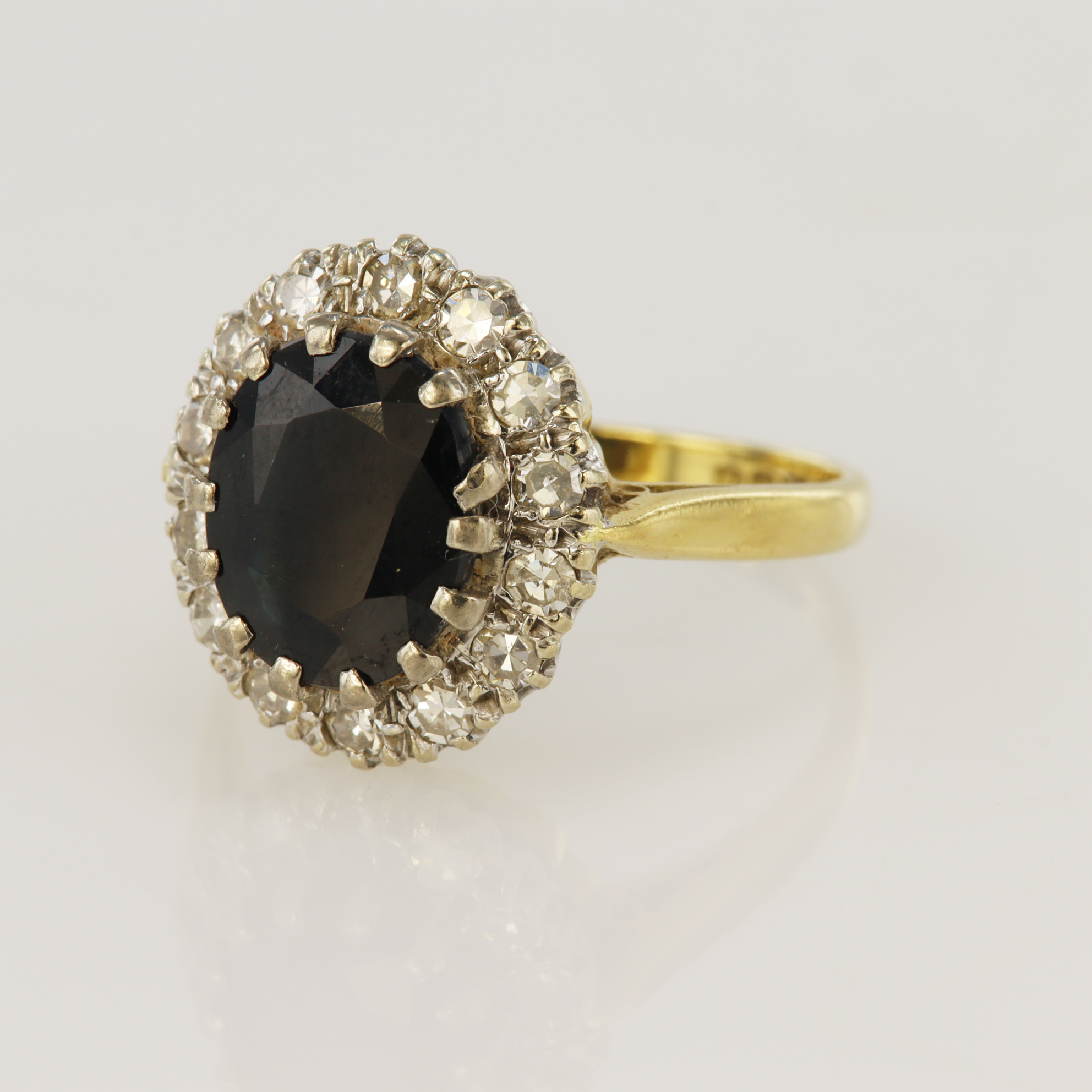 18ct yellow gold diamond and sapphire cluster ring, one oval sapphire measuring 10 x 7mm, surrounded