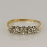 18ct yellow and white gold graduated five stone ring set with five round old cut diamonds with an