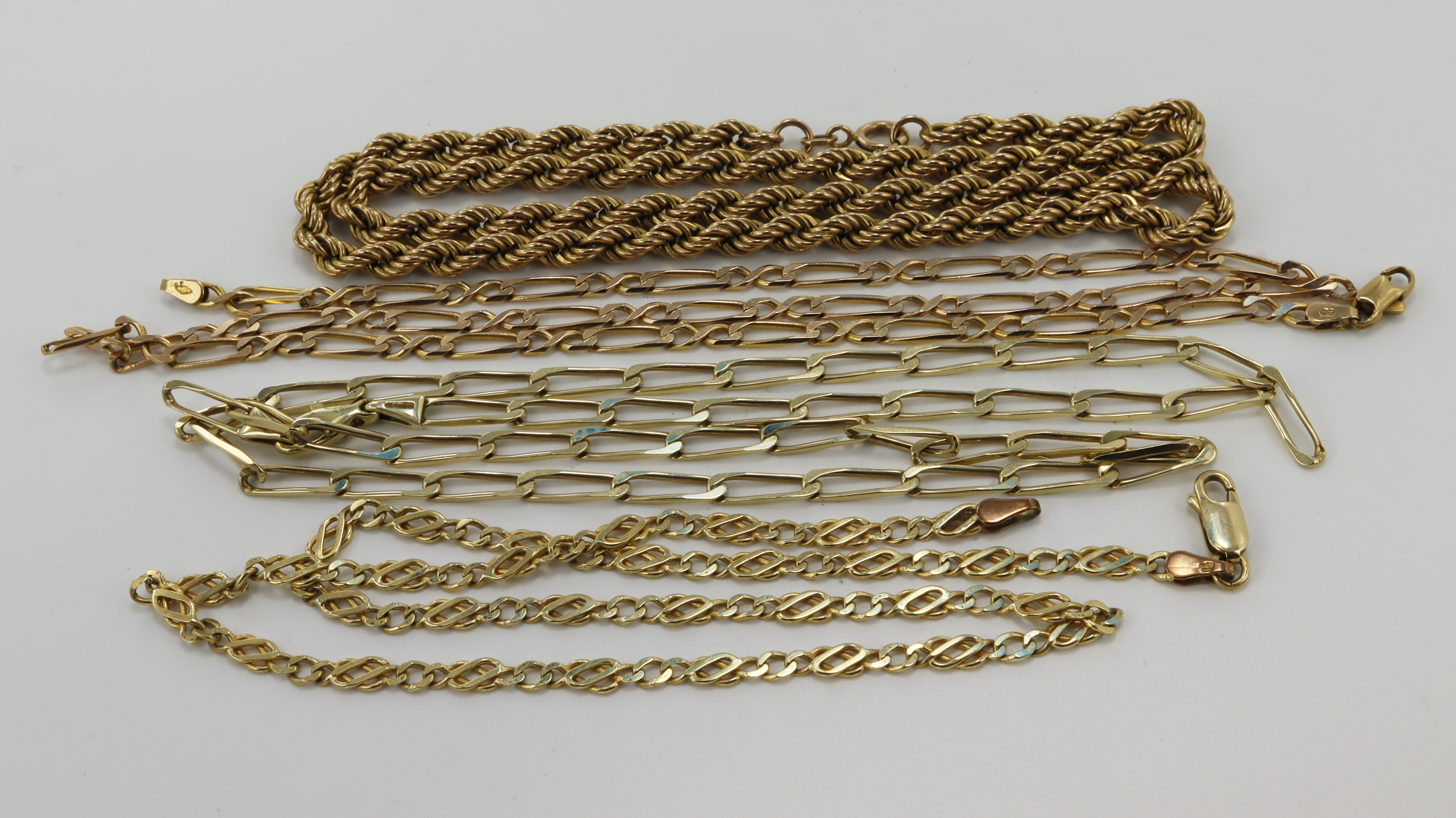 Four 9ct yellow gold chains, lengths 16.5", 18", 18.5", 20", total weight 34.5g.