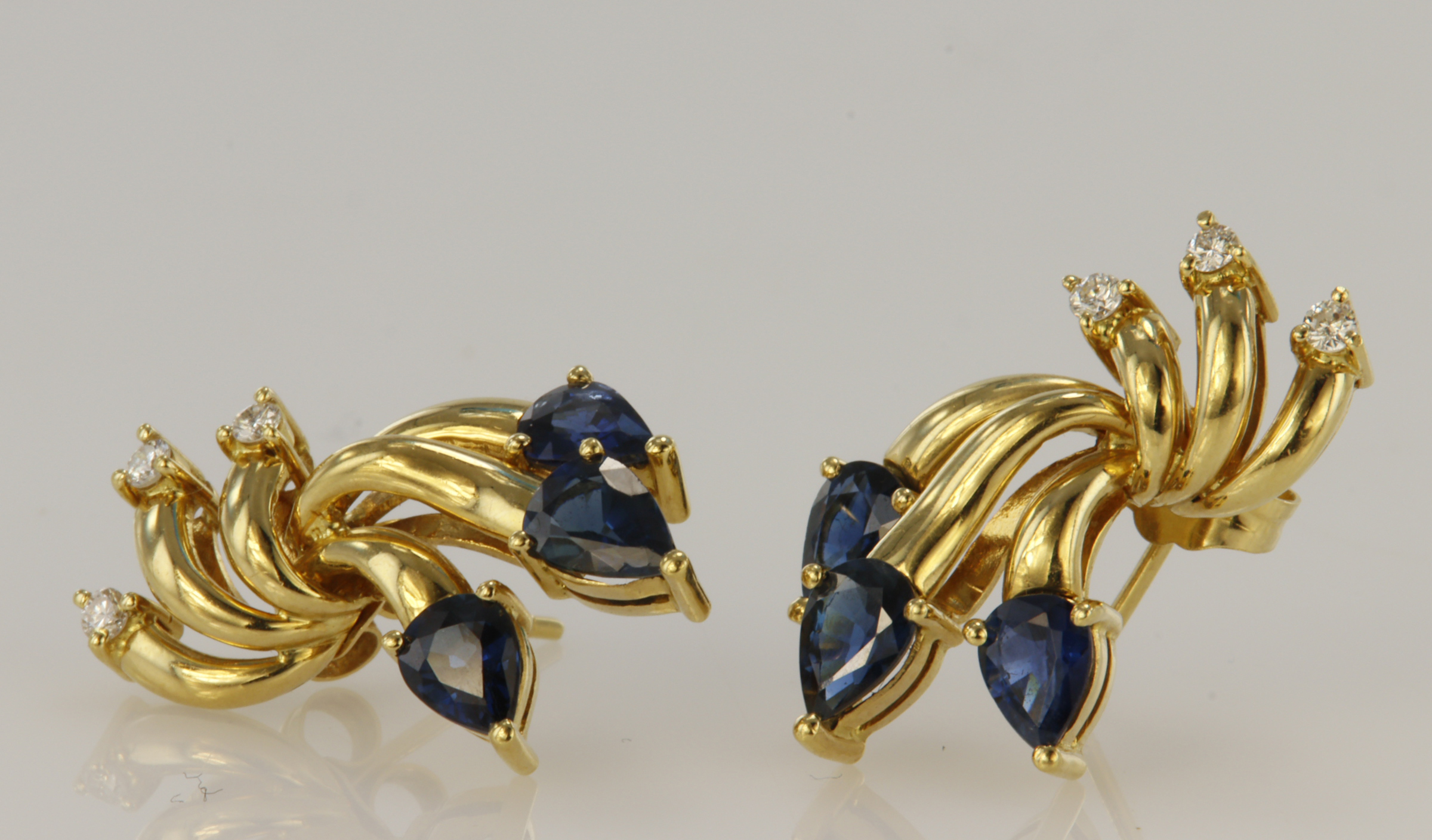 Tested as 18ct yellow gold sapphire and diamond earrings with post and butterfly fittings. Each