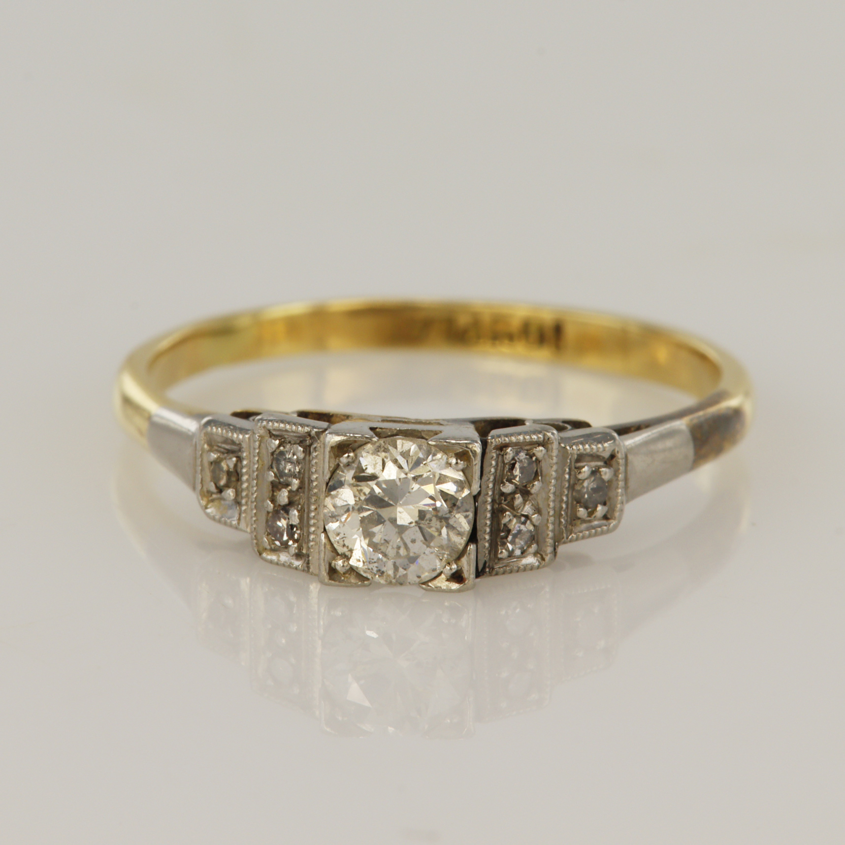 Yellow gold (tests 18ct) vintage diamond dress ring, one round brilliant cut approx. 0.27ct, flanked