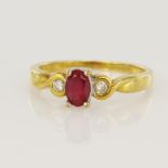 18ct yellow gold diamond and ruby trilogy ring, one oval ruby measuring 6x4mm, two round brilliant