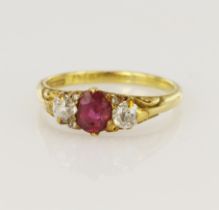 Yellow gold (tests 18ct) antique diamond and ruby trilogy ring, oval ruby measures 6 x 4.5mm, two